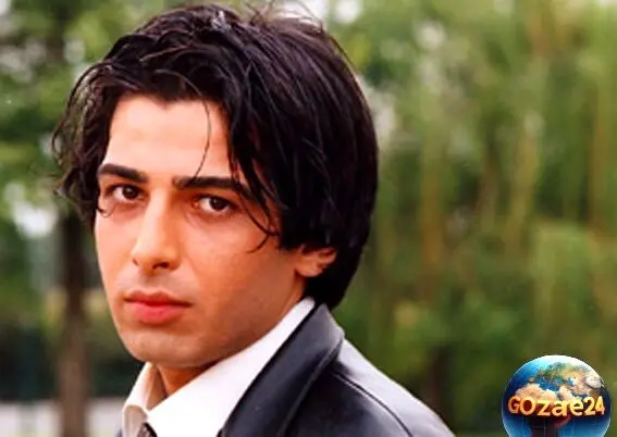 استایل خاص و گنگ حمید گودرزی در قلب اروپا با کت جین، عینک دودی و کوله پشتی